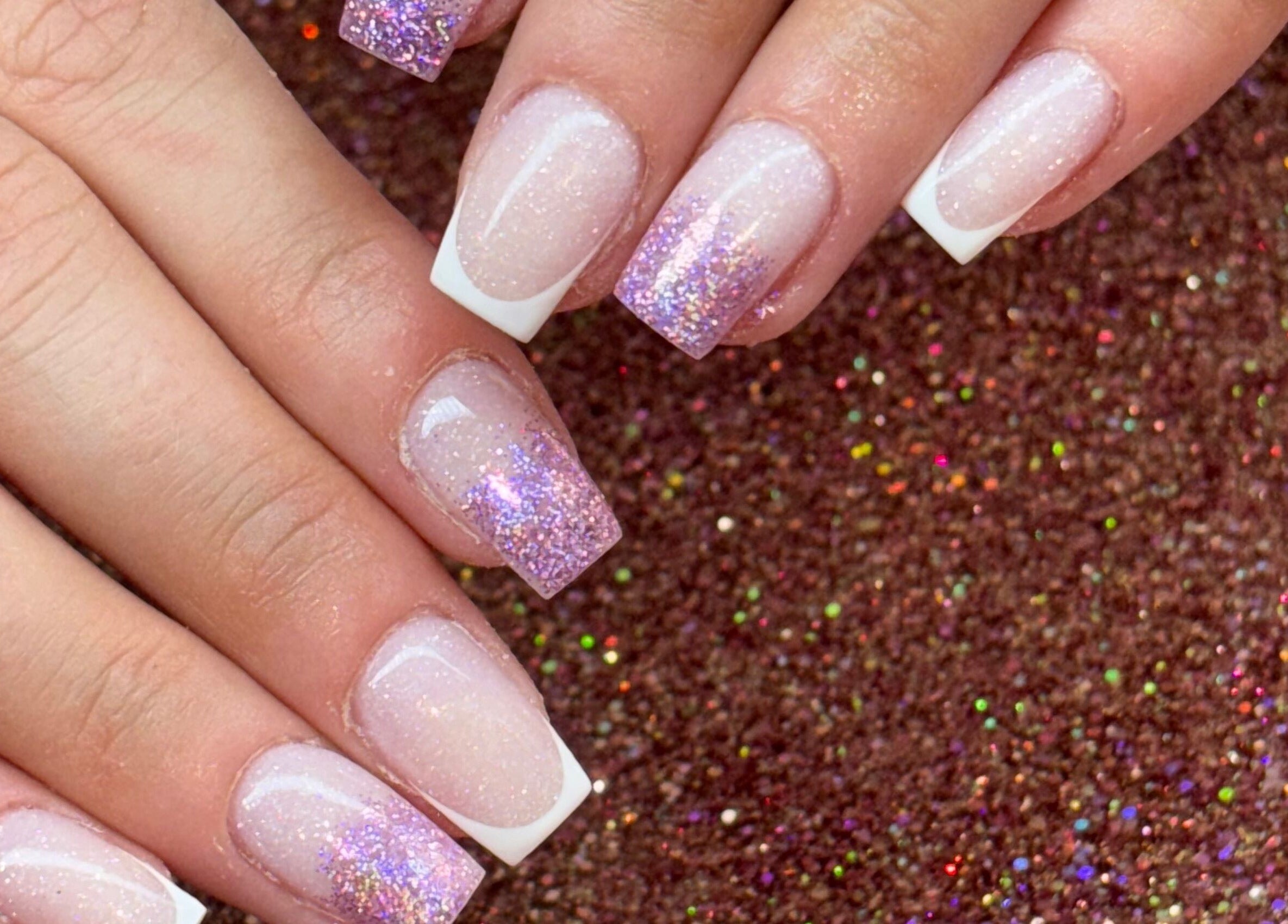 Glittery French manicure at Luxe Beauty MK, Crownhill, England, GB. Perfect for a stylish look.