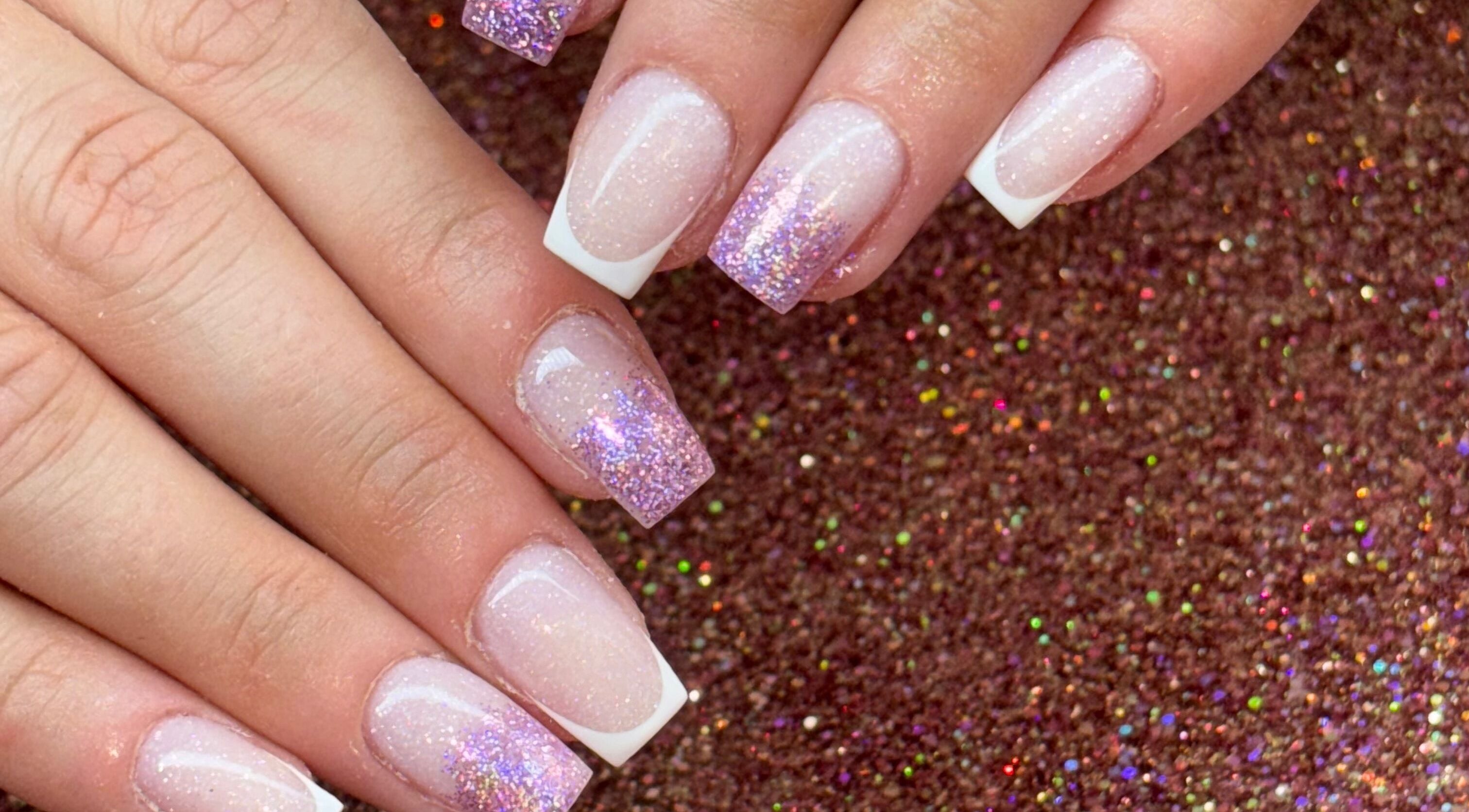 Glittery French manicure at Luxe Beauty MK, Crownhill, England, GB. Perfect for a stylish look.