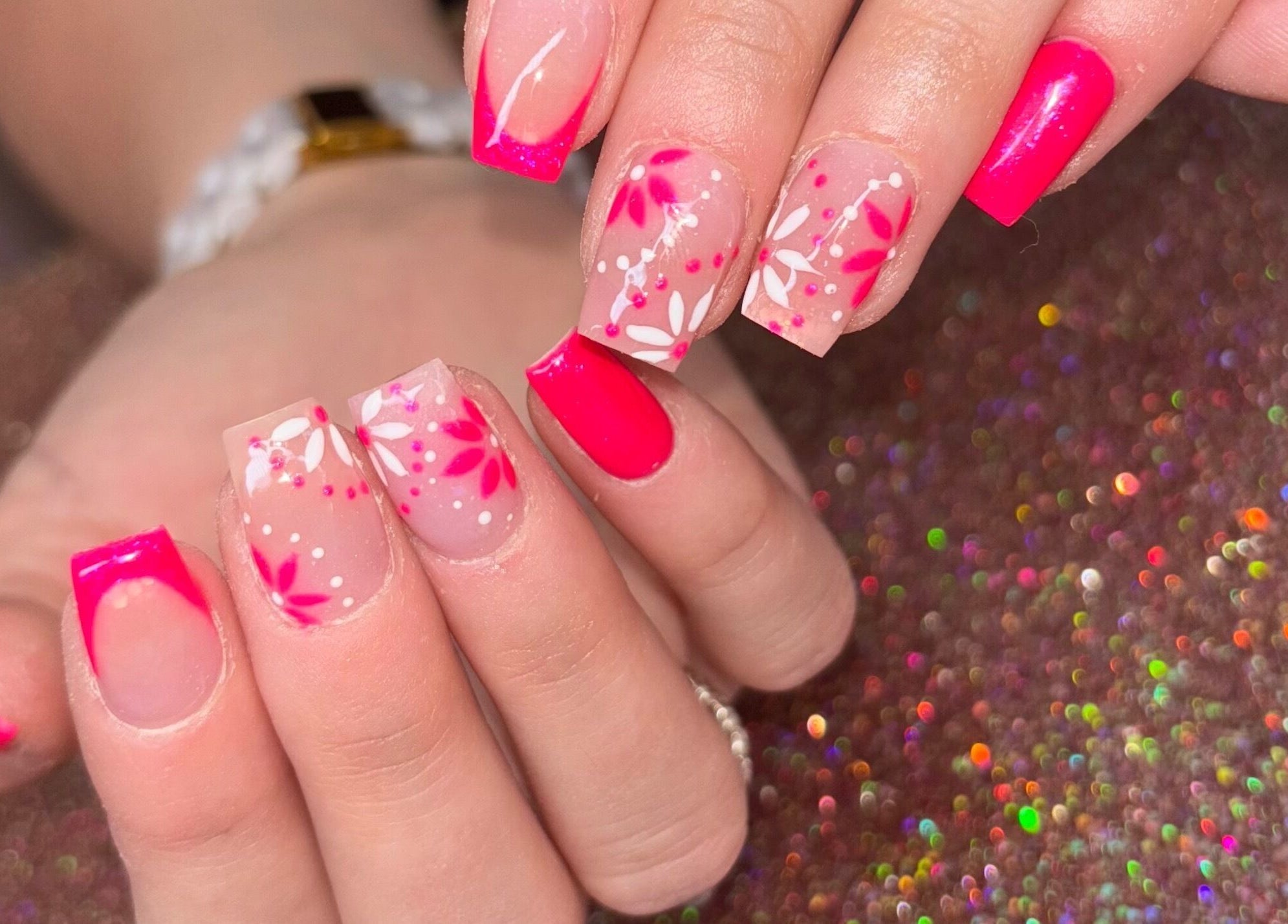 Bright floral nail art at Luxe Beauty MK, Crownhill, England, GB, showcasing intricate pink designs.