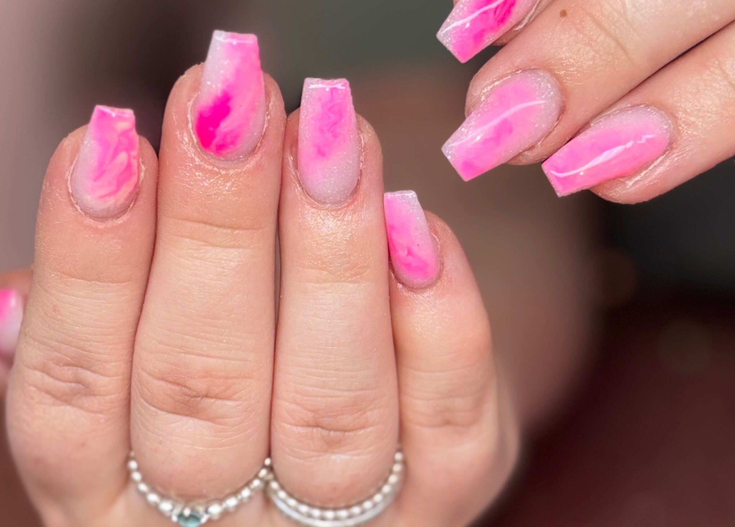 Vibrant pink nails with marble effect at Luxe Beauty MK, Crownhill, England, GB.