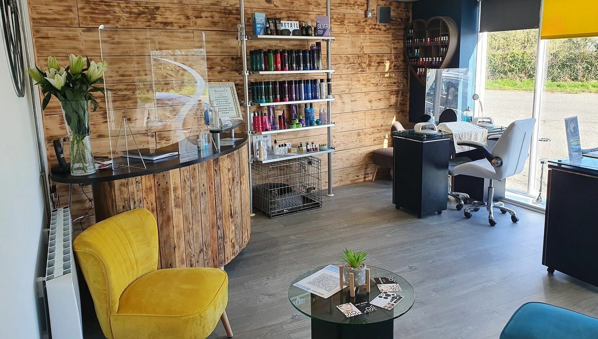 Modern beauty salon interior at Illusions, Redruth, England, GB, featuring vibrant decor and serene ambiance.