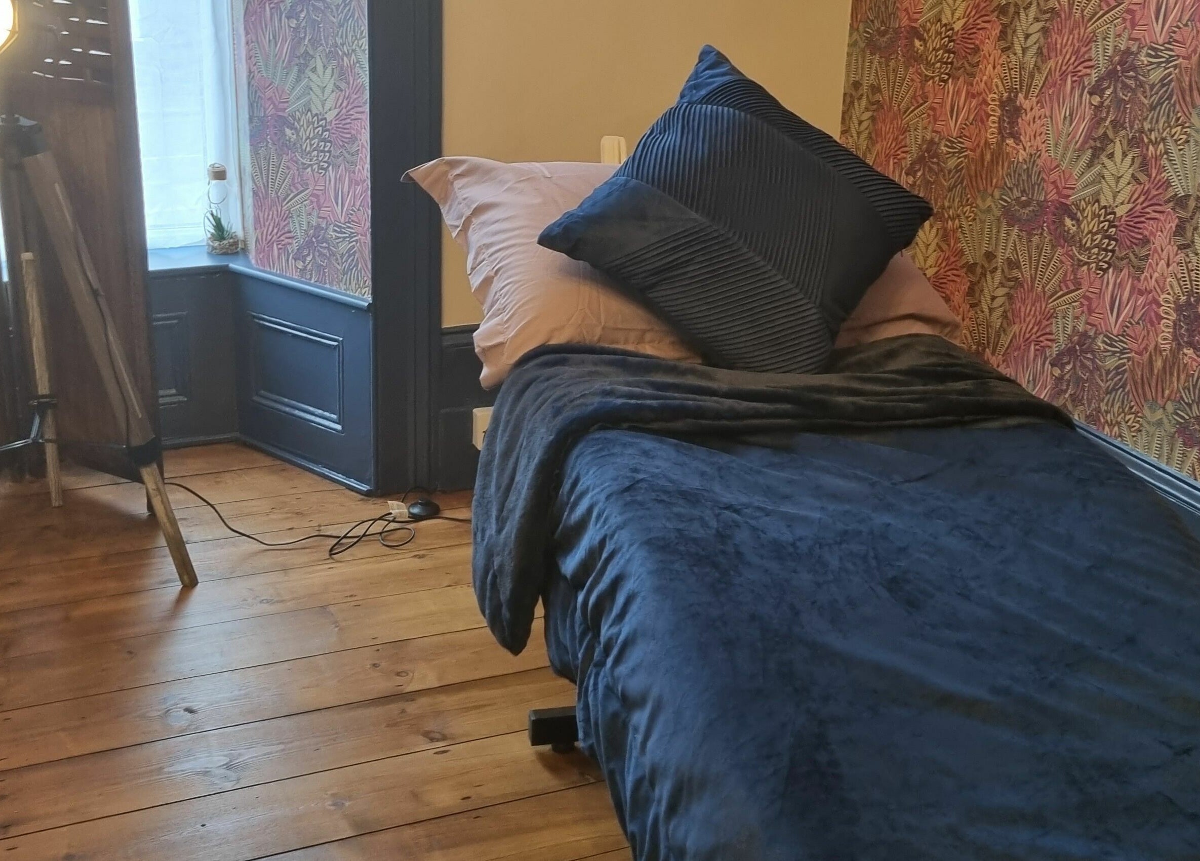 Tranquil treatment room at Illusions, Redruth, England, GB featuring stylish decor and warm lighting.