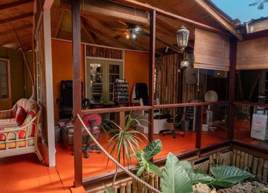 Relaxing interior of The Bamboo Retreat, St. George, BB with cozy seating and vibrant decor.