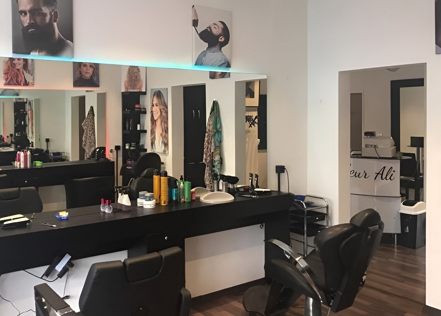 Stilvoller Innenraum von Coiffeur Ali in Zürich, Zürich, CH, mit Friseurstühlen und Spiegeln.