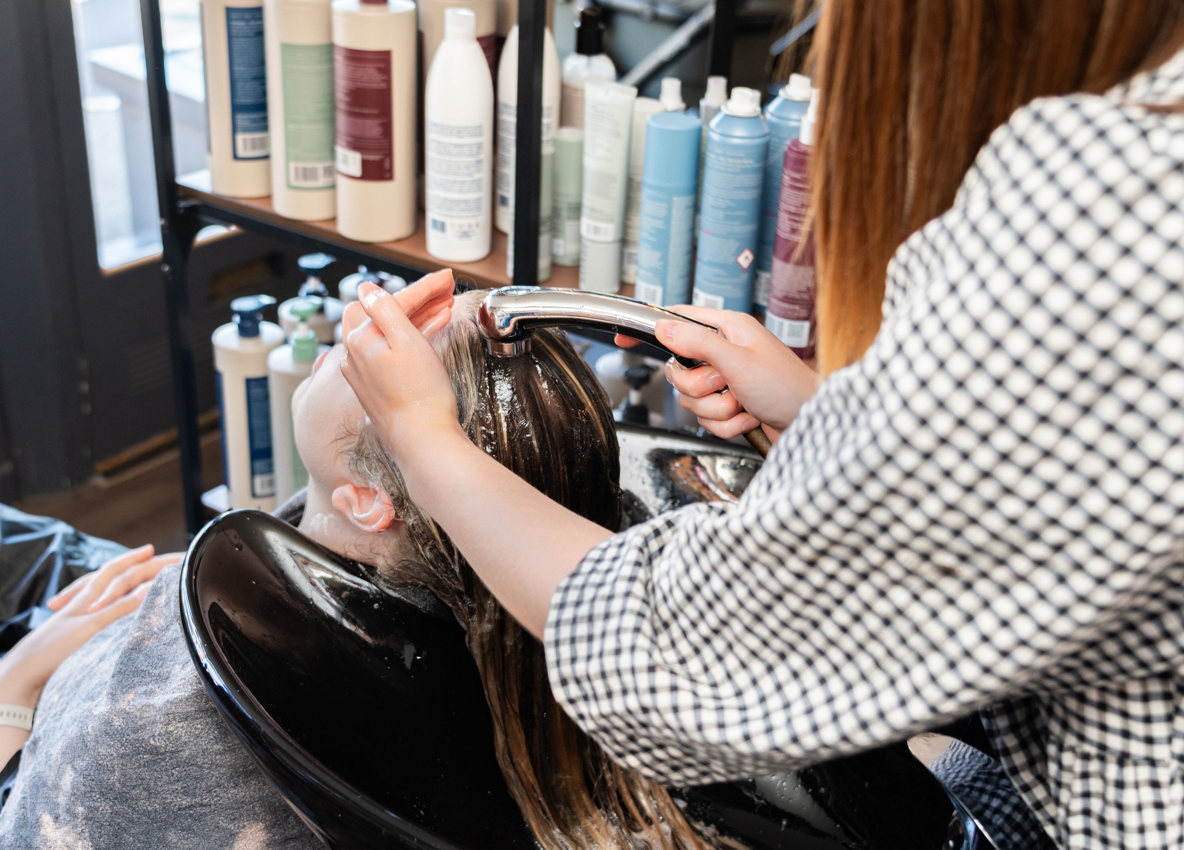 Hair treatment at Chandler & Hall, Southbourne, England, GB, featuring expert shampoo service.