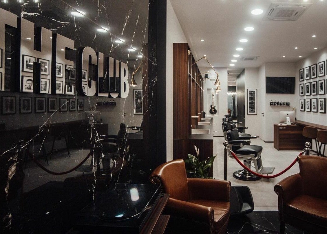 Interno moderno di The Club Barbershop - Adria, Veneto, IT con sedie di lusso e decorazioni uniche.
