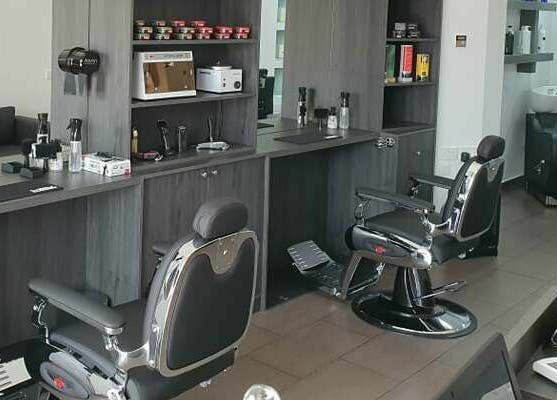Sleek barber chairs at Udomo Barber and Nail Studio, Paphos, Paphos, CY, showcasing a modern, stylish interior.