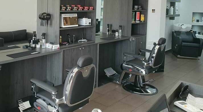 Sleek barber chairs at Udomo Barber and Nail Studio, Paphos, Paphos, CY, showcasing a modern, stylish interior.
