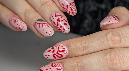 Artistic pink and red nail design at Killer Klaws, Cardiff, Wales, GB.