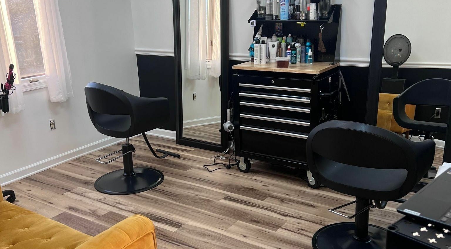 Elegant interior of The Color Lab in Harrisonburg, Virginia, US showcasing modern salon chairs and styling tools.