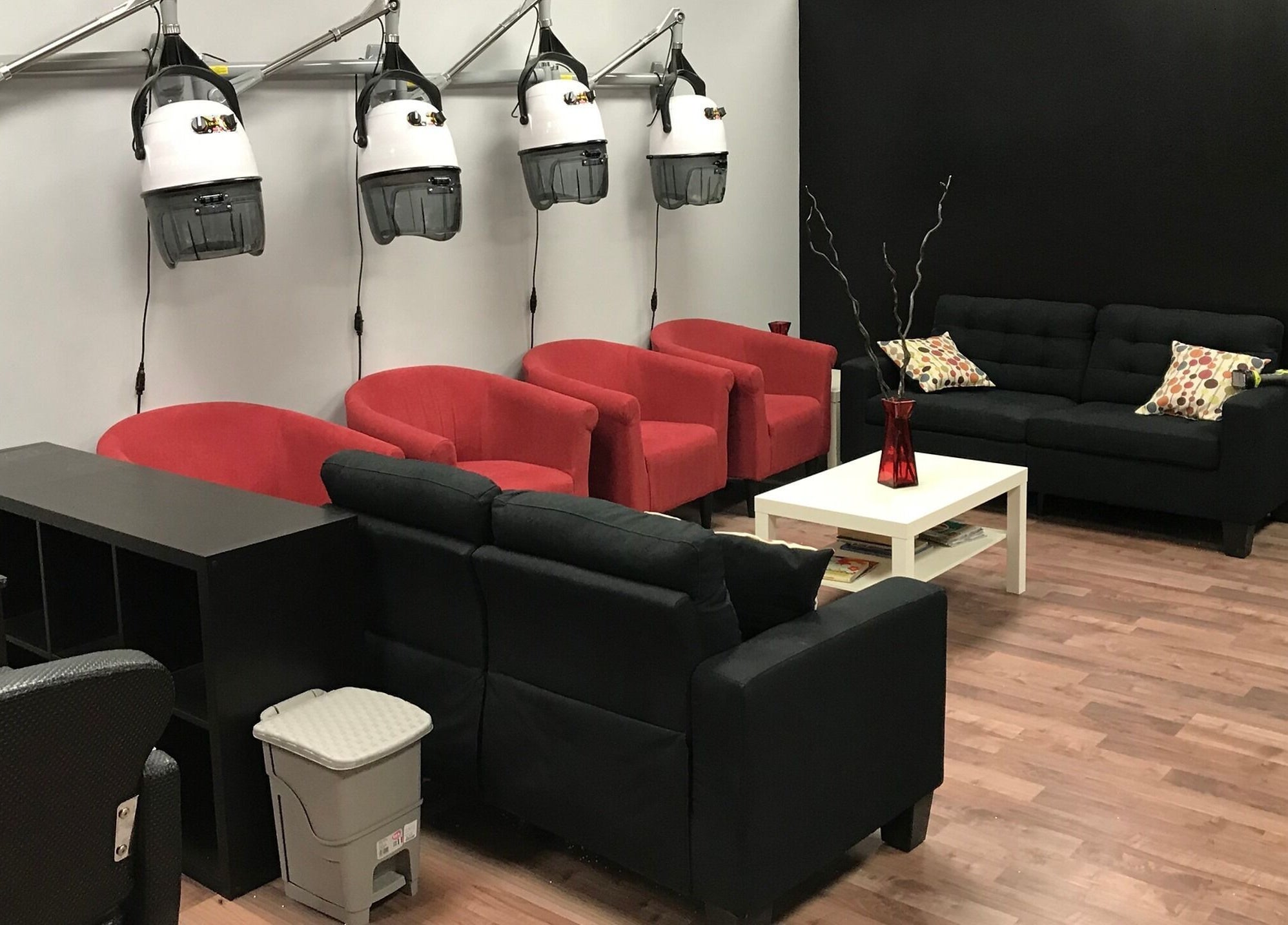 Stylish waiting area at Xclusive Salon Suites in Clinton, Maryland, US, featuring red and black seating.