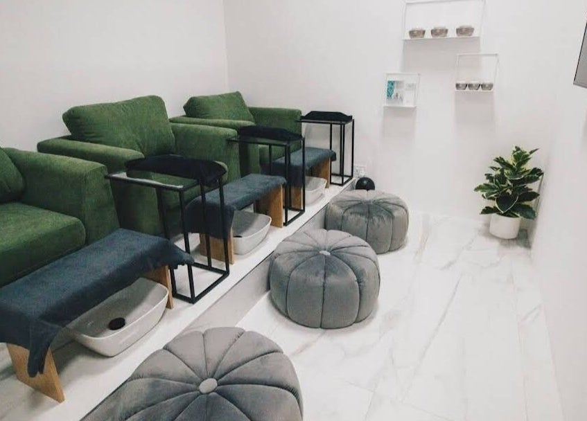 Cozy interior of Mani & Chill, Habitat Centre, Cape Town offering plush seats and foot baths for relaxation.
