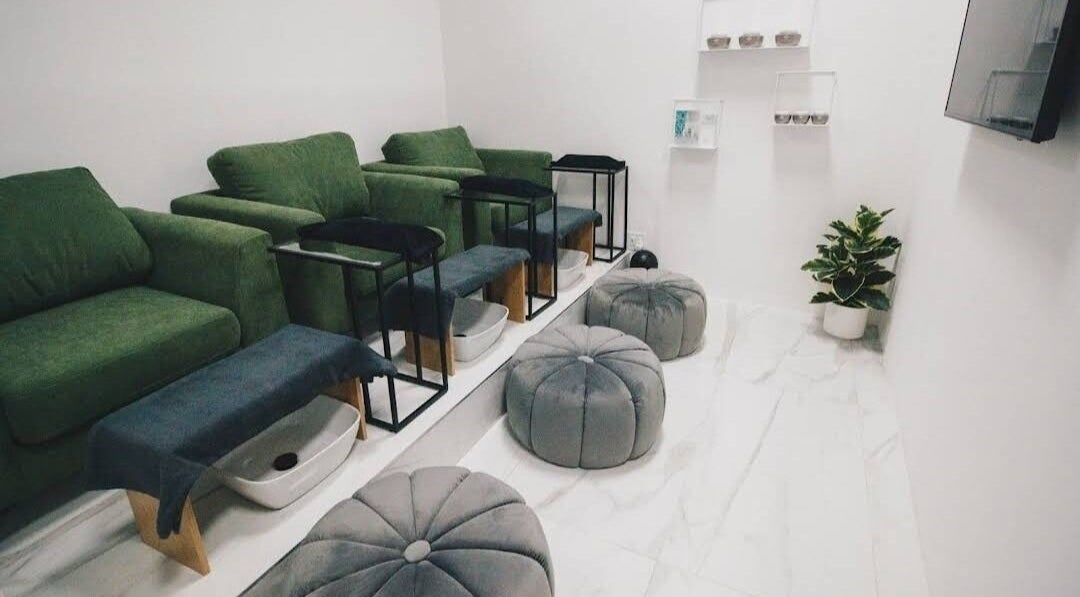 Cozy interior of Mani & Chill, Habitat Centre, Cape Town offering plush seats and foot baths for relaxation.