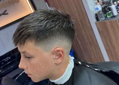 Youth with fresh fade haircut at The Men's Grooming Circular Quay Gateway, Sydney, New South Wales, AU.