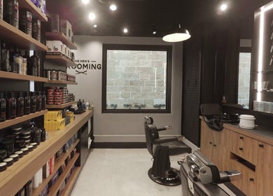 Interior of The Mens Grooming - Quay Quarter in Sydney, NSW, showcasing barber chairs and product shelves.