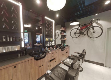 Interior of The Mens Grooming - Quay Quarter, Sydney, New South Wales, AU, showcasing stylish barber chairs and decor.