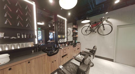 Interior of The Mens Grooming - Quay Quarter, Sydney, New South Wales, AU, showcasing stylish barber chairs and decor.