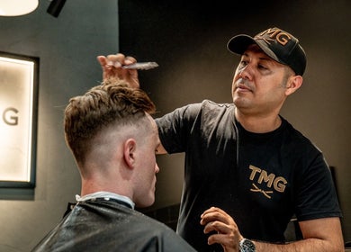 Expert stylist at The Mens Grooming - Quay Quarter in Sydney, New South Wales, AU offers a precise haircut.