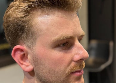 A close-up of a well-groomed man at The Mens Grooming - Quay Quarter, Sydney, New South Wales, AU.