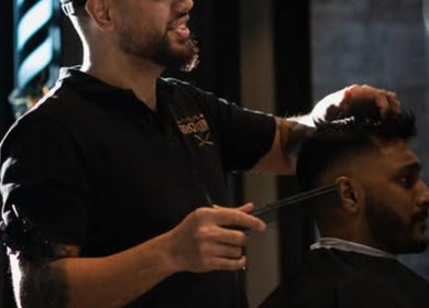 Barber at The Men's Grooming Circular Quay Gateway, Sydney, New South Wales, AU giving a stylish haircut.