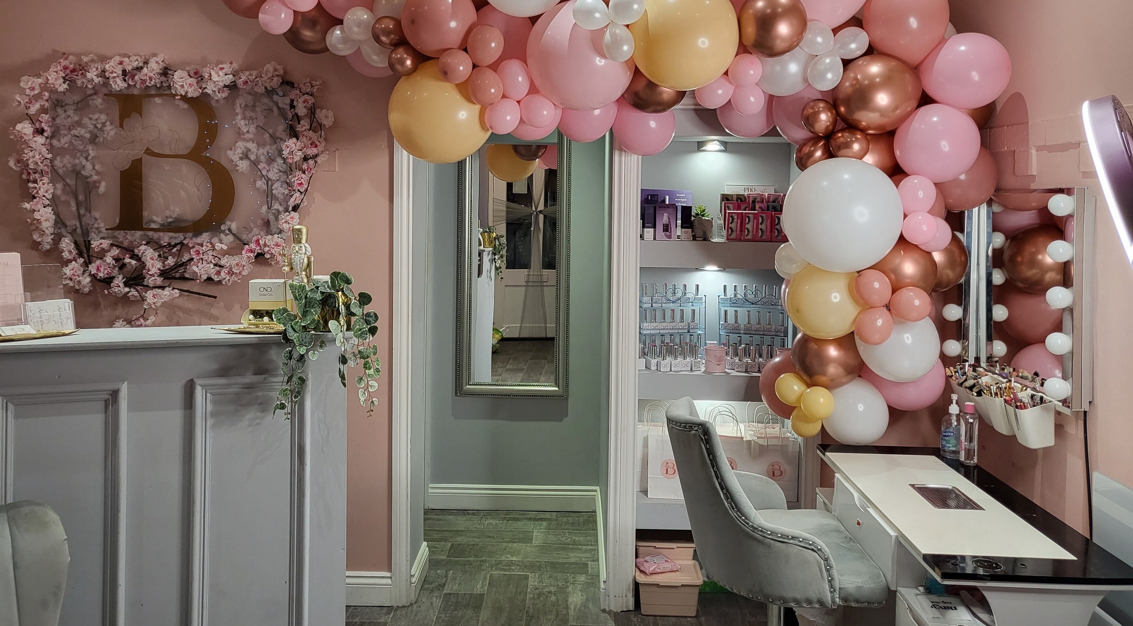 Elegant Blossom Beauty reception in Halifax, England with pink balloon decor and floral accents.