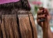 Hair extensions being applied at HairPlusTT, Port of Spain, Port of Spain Corporation, TT.
