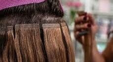 Hair extensions being applied at HairPlusTT, Port of Spain, Port of Spain Corporation, TT.