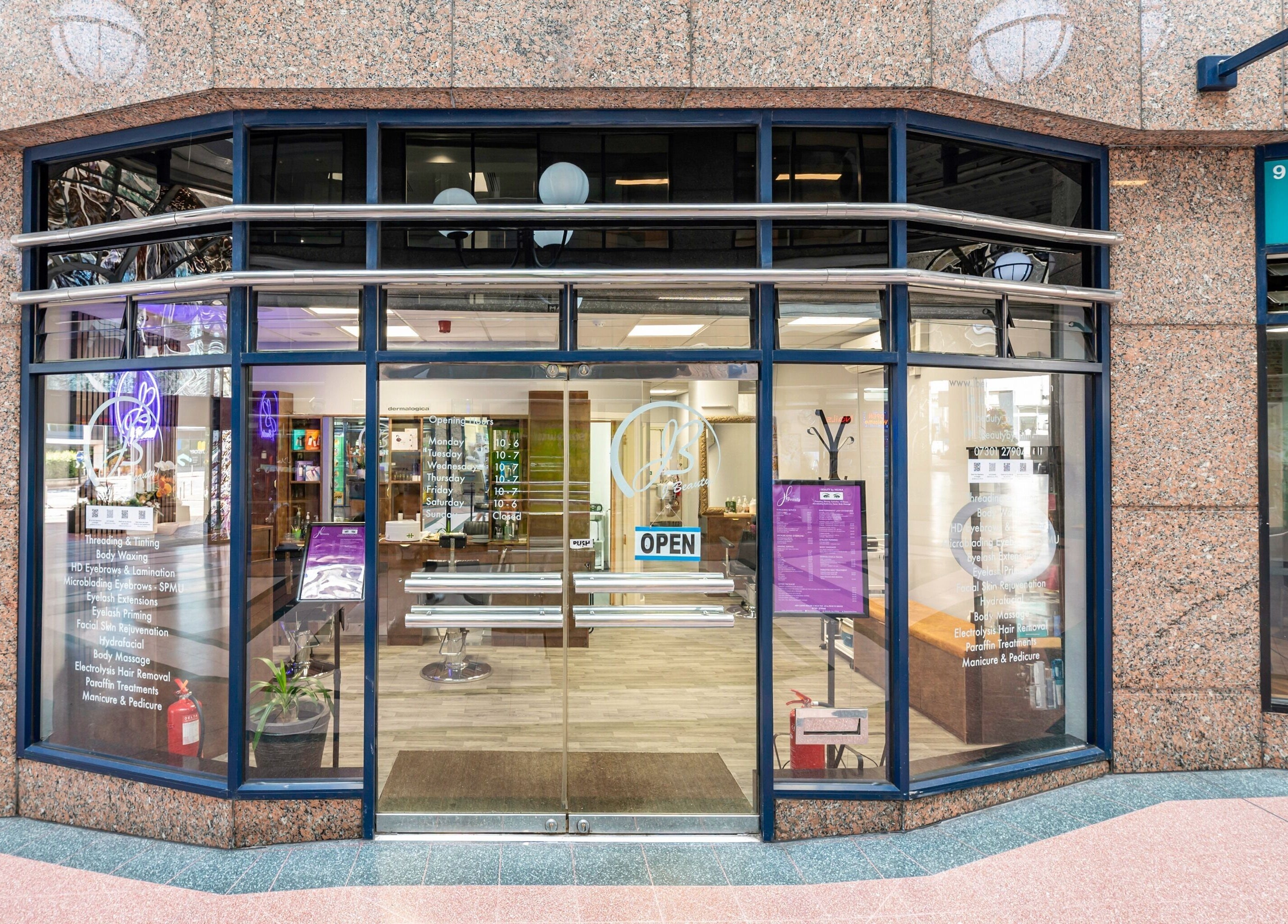 Front view of J Beauty by Nilima, a stylish venue in Birmingham, England, GB with glass doors and a welcoming sign.