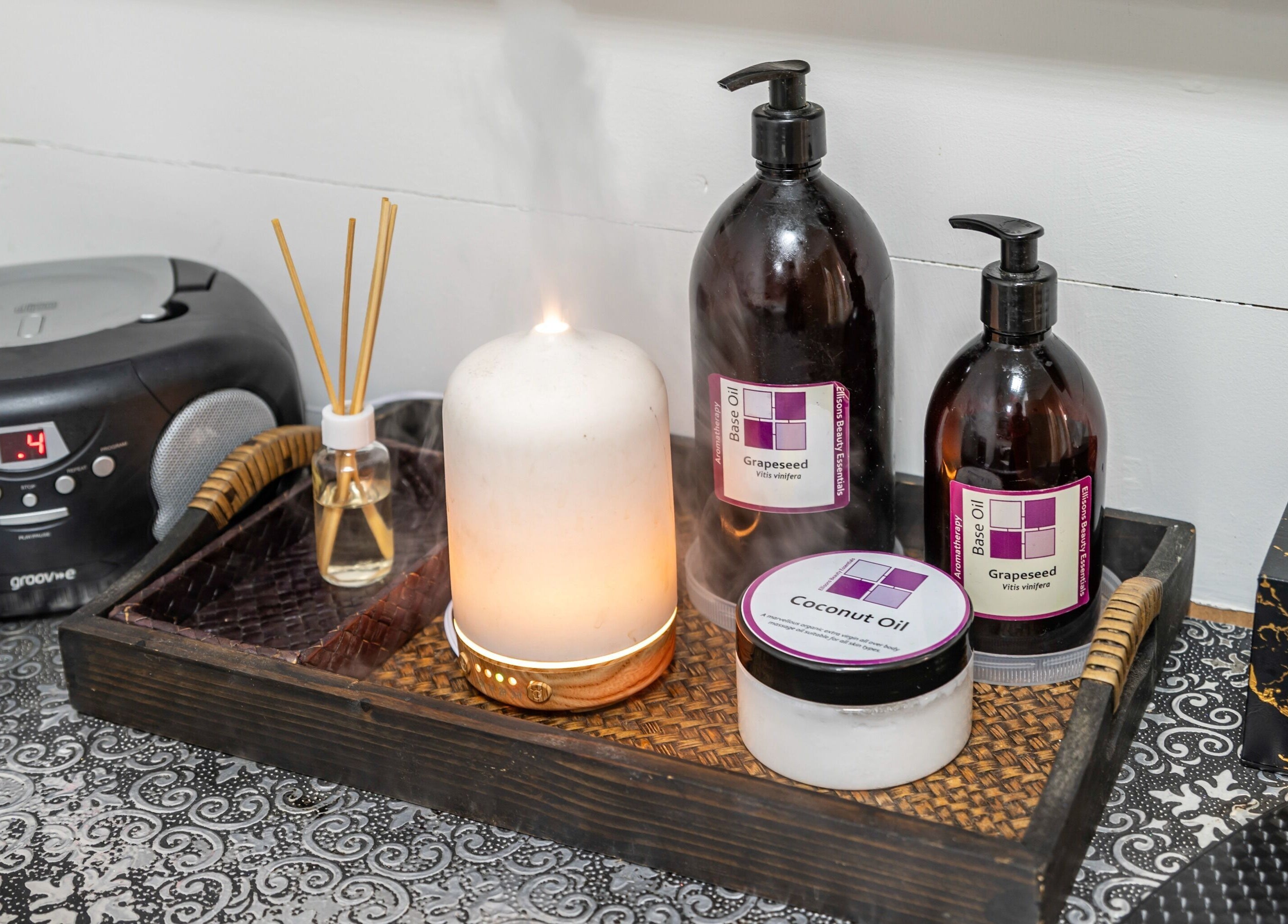 Relaxing spa setup with oils and candle at J Beauty by Nilima, Birmingham, England, GB.