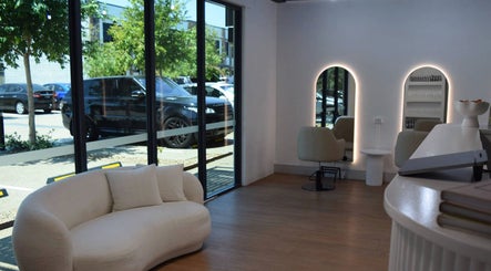 Modern interior of Hair by Jessie - Hervey Bay in Pialba, Queensland, AU with stylish seating and large windows.