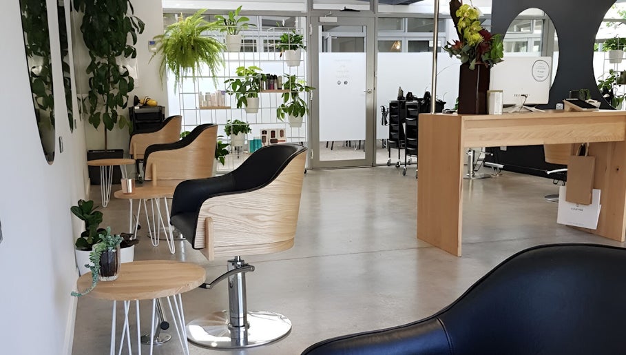 Modern salon interior with wooden chairs at Charles St. Launceston Tasmania, Launceston, Tasmania, AU.
