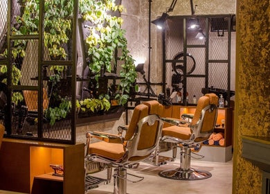 Luxury salon chairs at The Lair Man, Mumbai, Maharashtra, IN with stylish decor and ambient lighting.