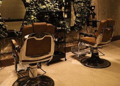 Stylish salon chairs at The Lair Man in Mumbai, Maharashtra, IN with lush greenery adding a relaxing vibe.