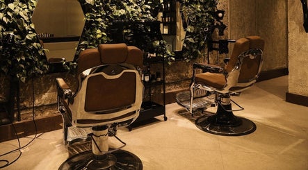 Stylish salon chairs at The Lair Man in Mumbai, Maharashtra, IN with lush greenery adding a relaxing vibe.