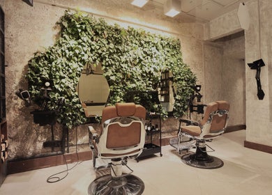 Chic salon interior with green wall at The Lair Man, Mumbai, Maharashtra, IN, offering a refreshing ambiance.