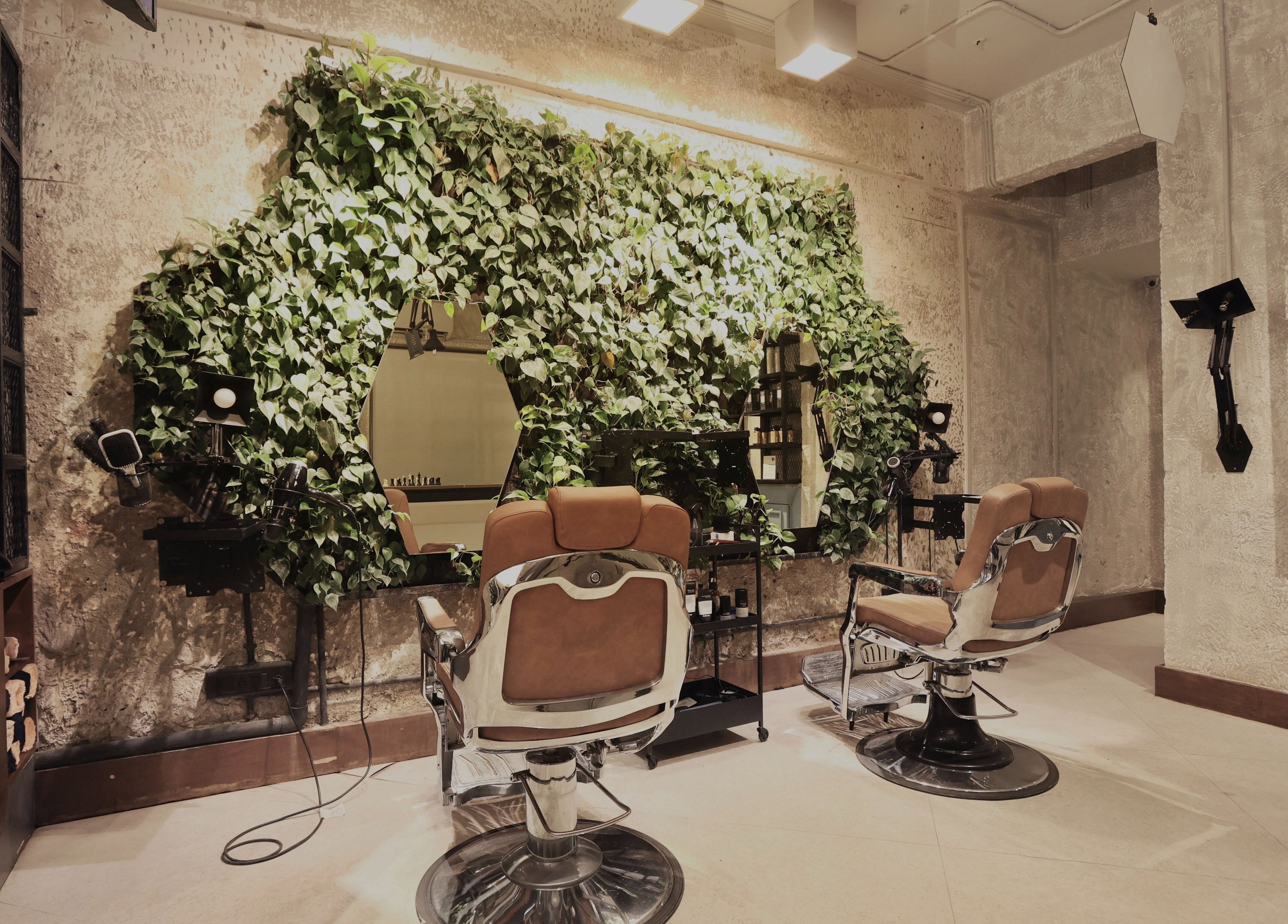 Chic salon interior with green wall at The Lair Man, Mumbai, Maharashtra, IN, offering a refreshing ambiance.