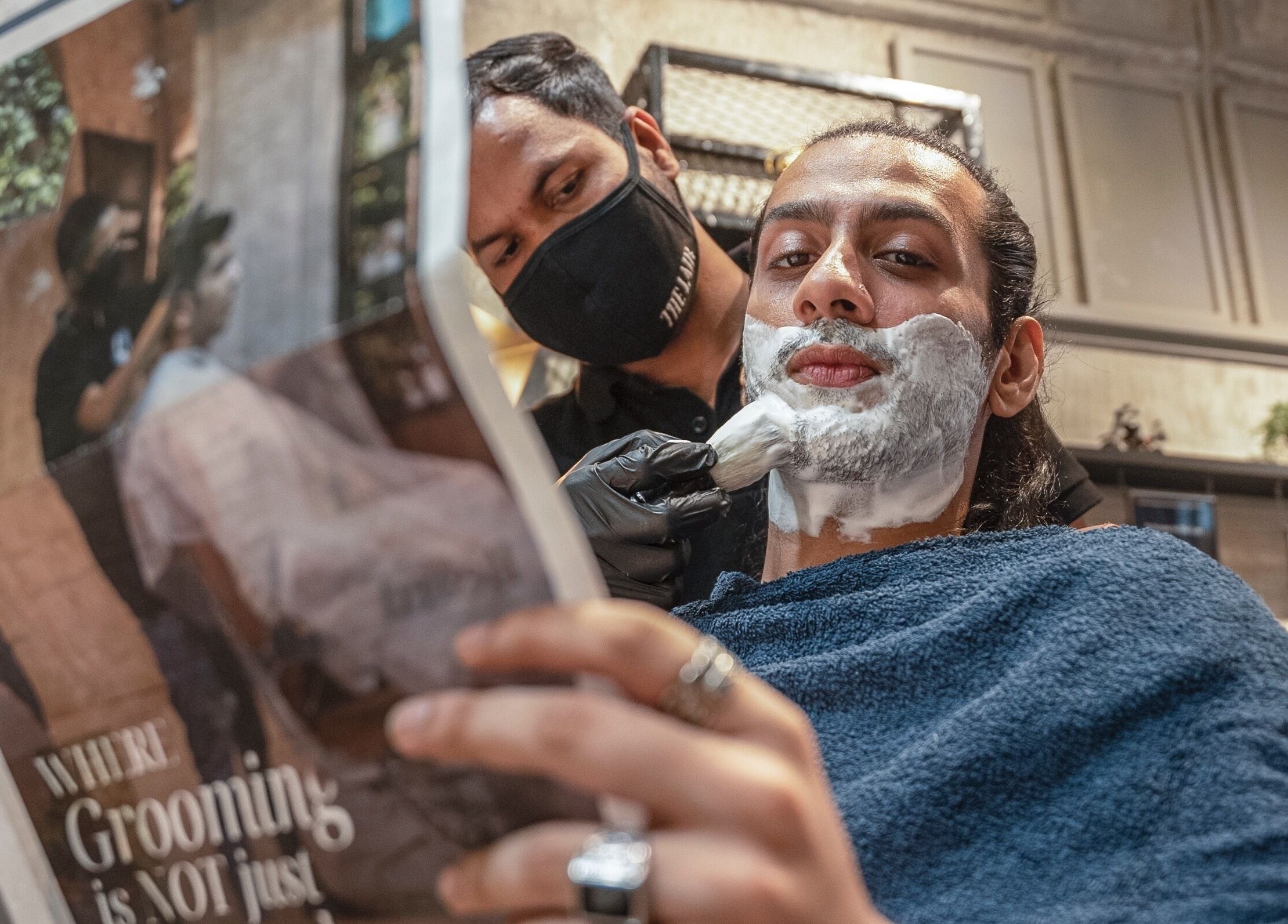 Gentleman receiving a shave at The Lair Man, Mumbai, Maharashtra, IN.