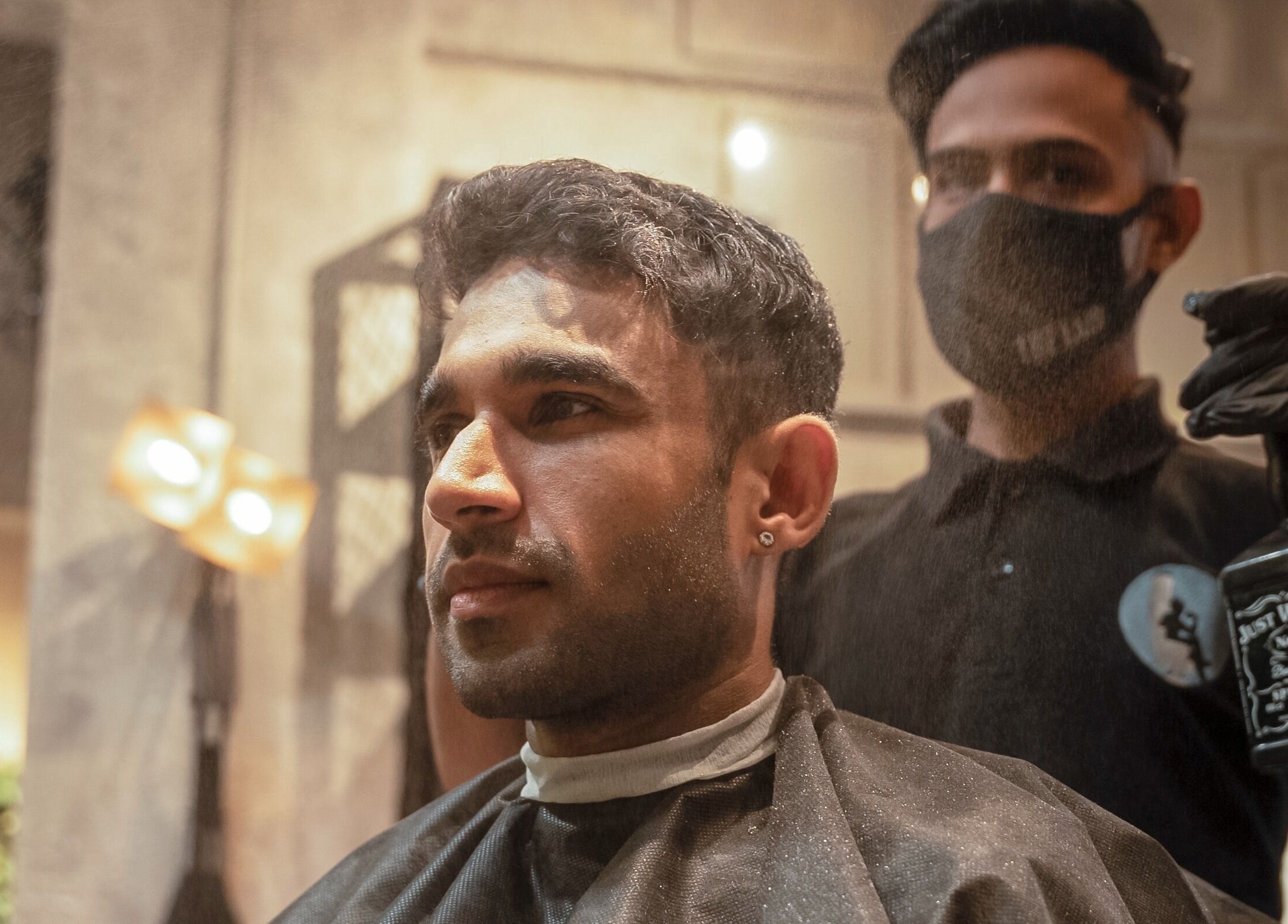 Stylist perfects a haircut at The Lair Man, Mumbai, Maharashtra, IN with precision and style.