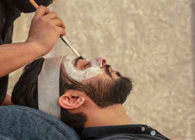 Man receiving a relaxing facial treatment at The Lair Man, Mumbai, Maharashtra, IN.
