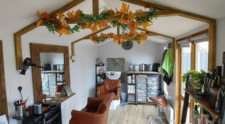 Cozy interior of The Hair Lodge in Wakefield, England, GB with autumn decor and salon chairs.