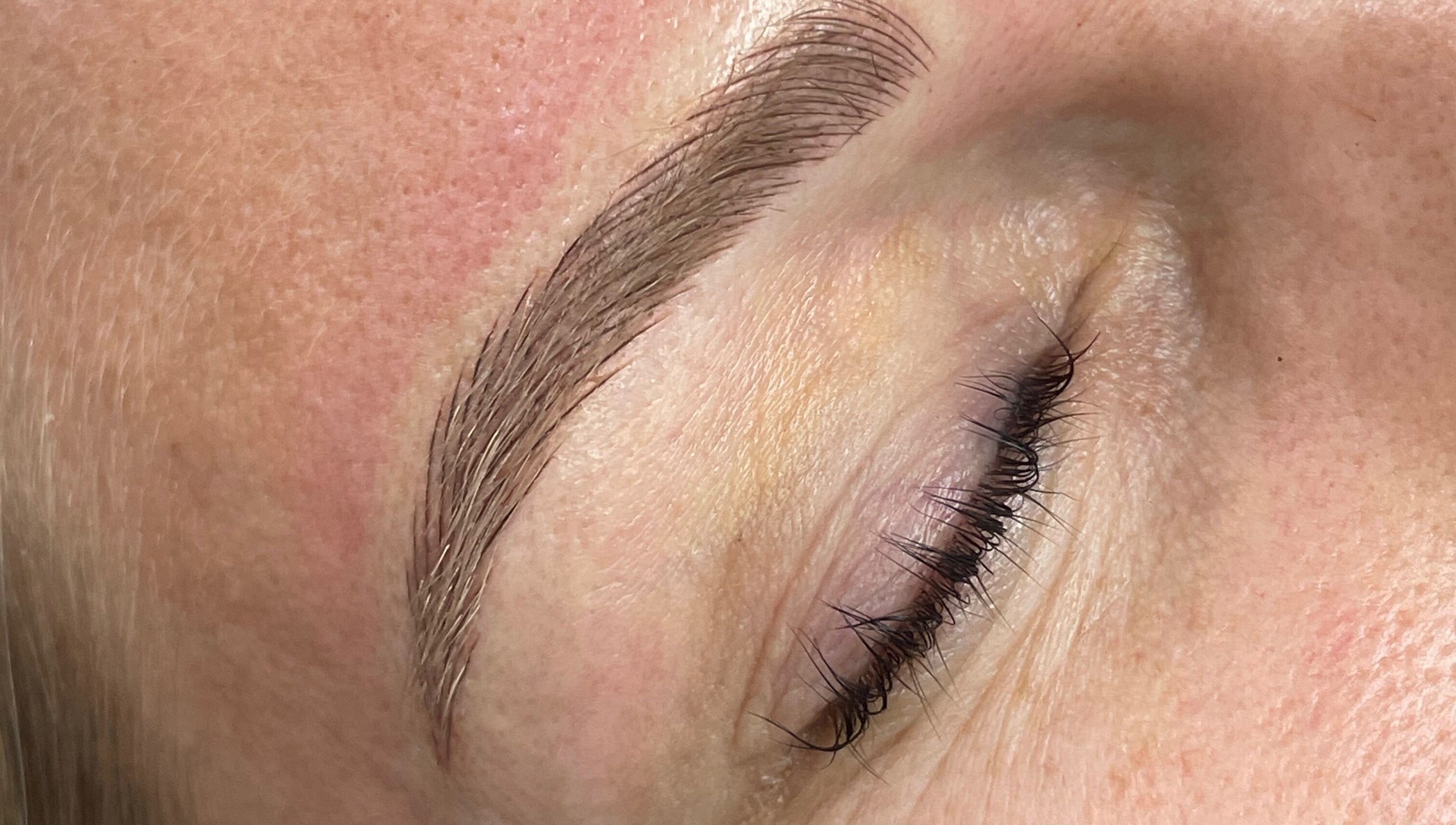 Close-up of professionally groomed eyebrow at Allure Lashes & Aesthetics, Sandton, Gauteng, ZA.