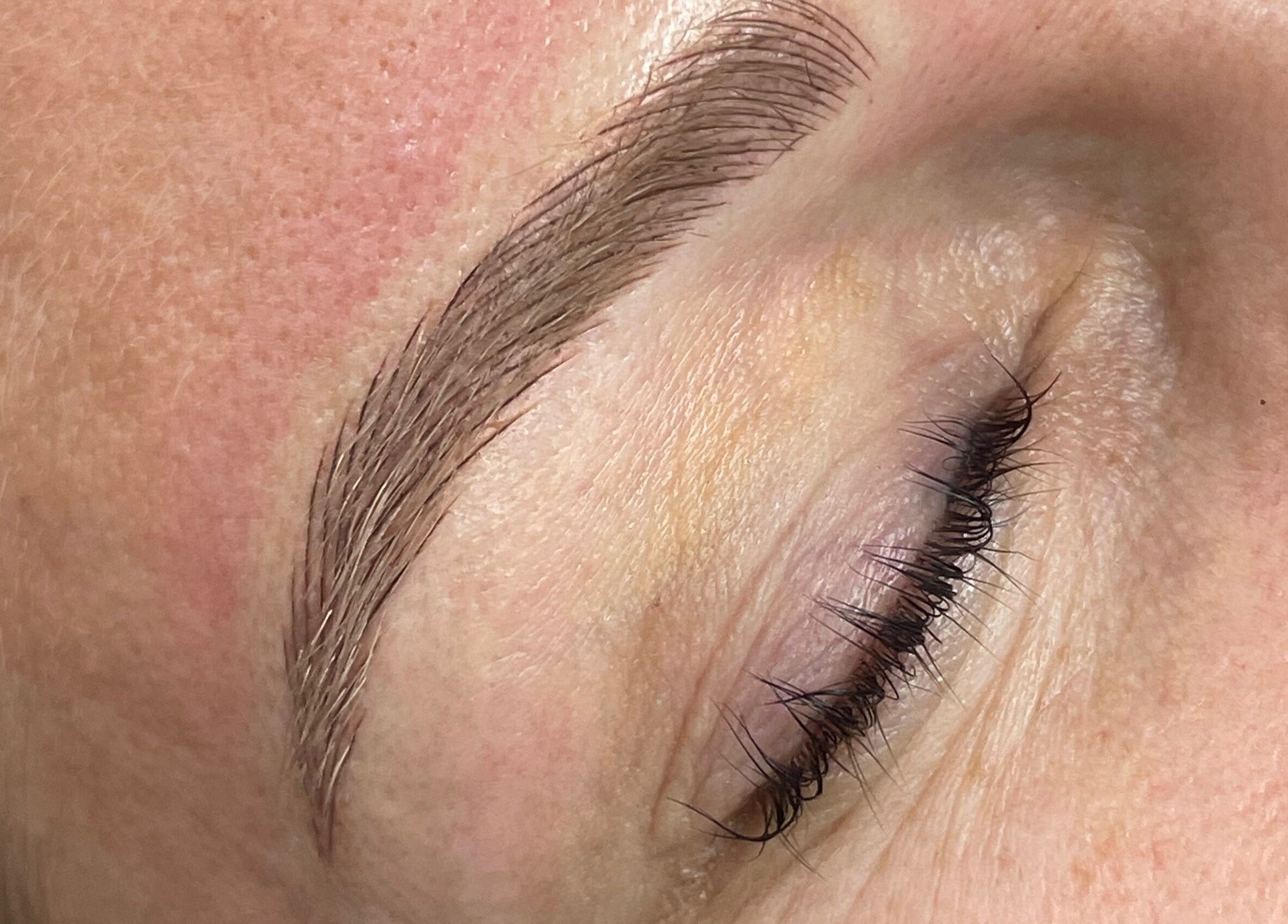 Close-up of professionally groomed eyebrow at Allure Lashes & Aesthetics, Sandton, Gauteng, ZA.