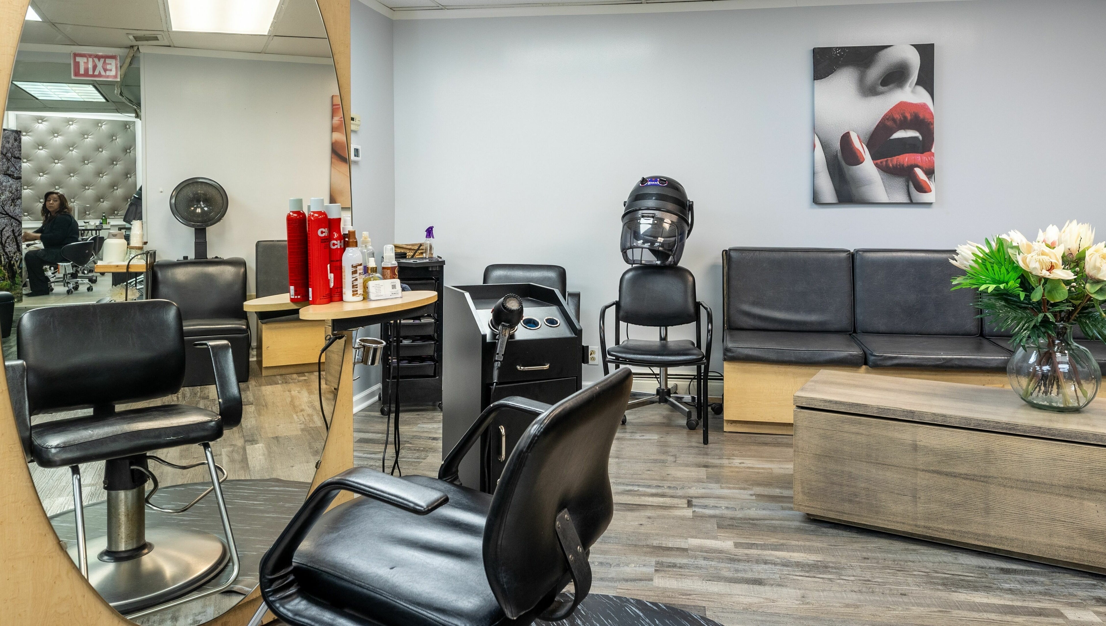 Elegant seating and styling area at Le Cache Salon, Newark, New Jersey, US, showcasing modern hair care setup.