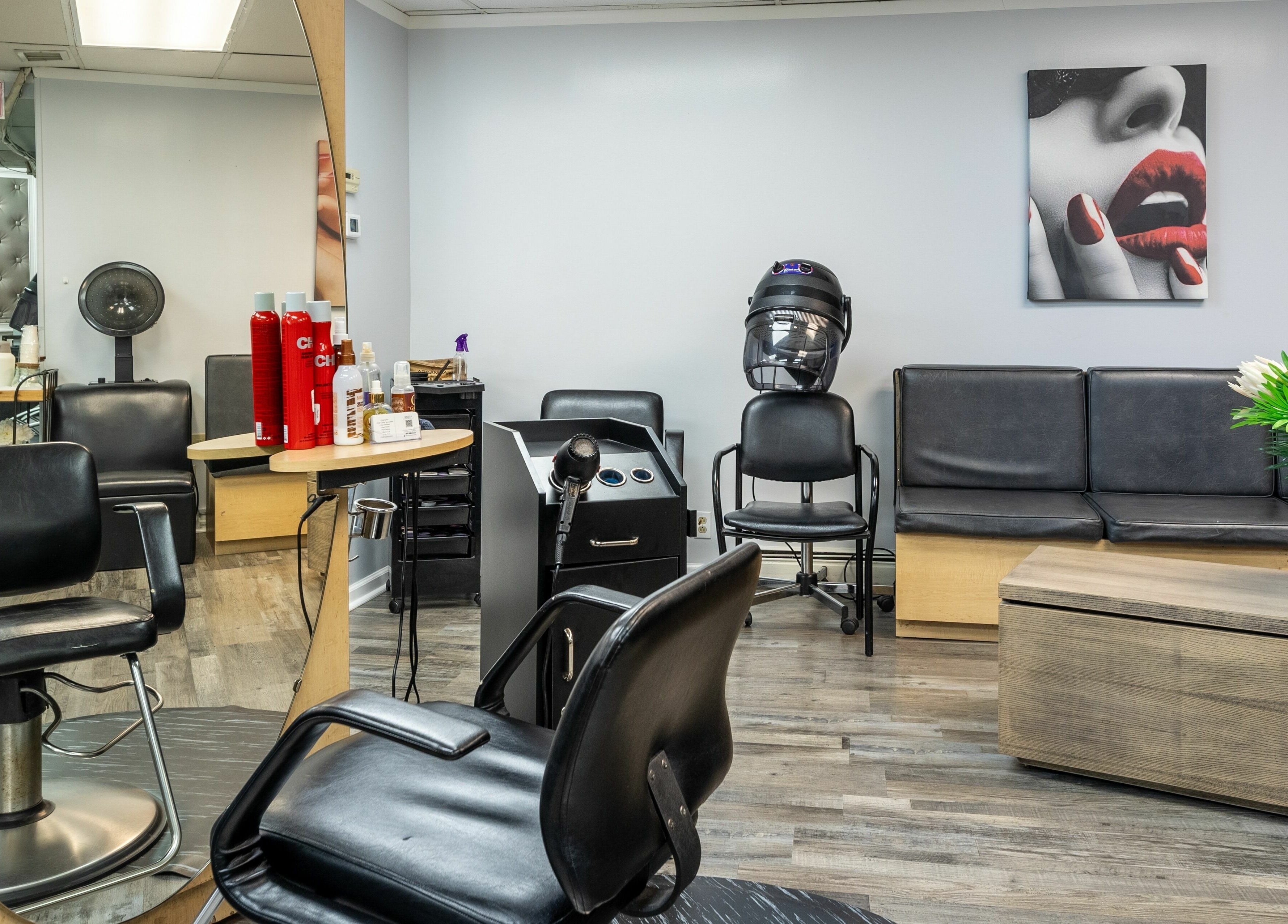 Elegant seating and styling area at Le Cache Salon, Newark, New Jersey, US, showcasing modern hair care setup.