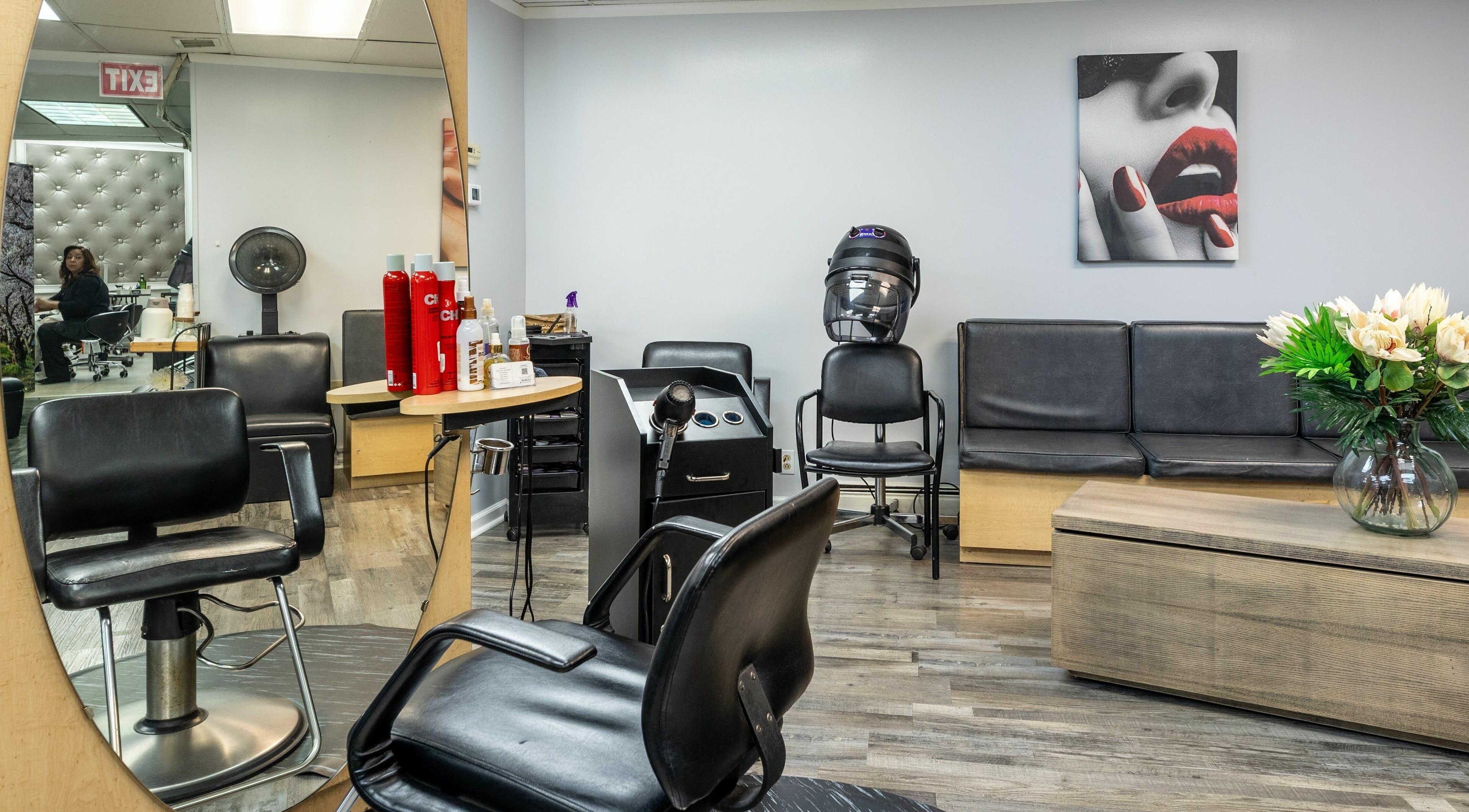 Elegant seating and styling area at Le Cache Salon, Newark, New Jersey, US, showcasing modern hair care setup.