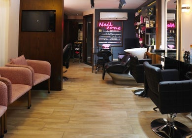 Interior of Nano Beauty Zone Salon in Damascus, showcasing sleek nail service area and stylish seating.