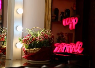 Vanity station with flowers and neon sign at Nano Beauty Zone Salon, Damascus, Damascus Governorate, SY.