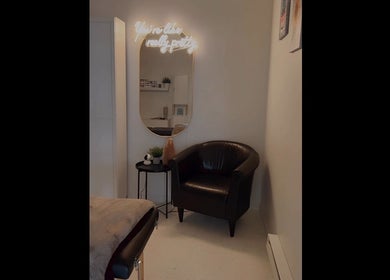 Relaxing corner with a chair and mirror at AFFINITY ARTISTRY DEN, Winnipeg, Manitoba, CA.