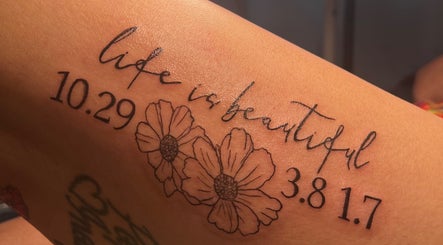 Artistic floral tattoo with text 'Life is beautiful' at AFFINITY ARTISTRY DEN, Winnipeg, Manitoba, CA.
