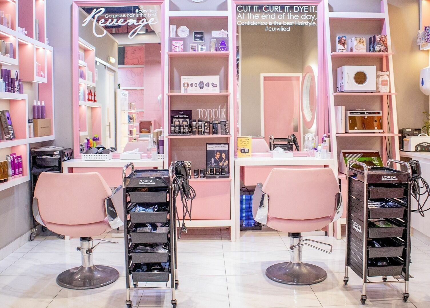 Curve Beauty Salon's stylish interior in Dubai, Dubai, AE, features elegant pink chairs and beauty products.